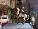 a statue of a man riding a horse in a living room
