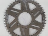 a close up of a motorcycle sprocking gear on a white surface