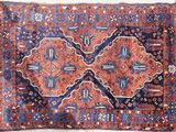 an old persian rug with a blue and red design on it