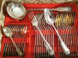 a red tray with silverware and spoons in it