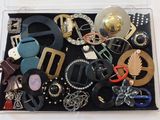 many different types of belts and buckles in a box