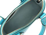 the inside of a blue handbag with a zipper on it