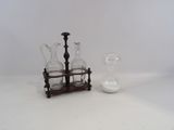 three glass vases and a candle holder on a table