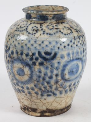 un vase bleu et blanc posé sur une surface blanche