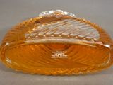 a yellow glass bowl with a leaf design on it