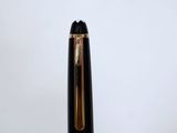 a close up of a fountain pen with a gold tip on a white background