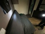 a bed that is in a room with a light on it