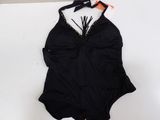 a bathing suit with a bow on the back and a black one piece swimsuit