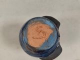 a blue and black blender with a brown substance in it