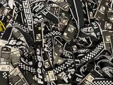 a pile of black and white lanyards on a table