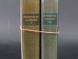 a pair of books sitting on top of each other on a table