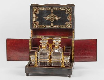 a small wooden box with a glass decanter in it