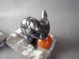 a statue of a cat that is sitting on a marble block