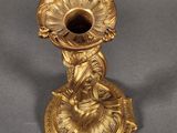 gold plated candle holder with a lady holding a flower