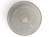 a white bowl with a brown rim sitting on a white surface