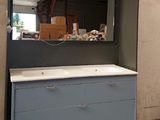 a mirror on the wall above a sink in a room