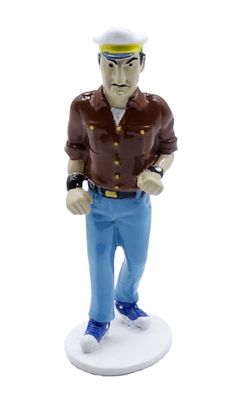 figurine of a man in a brown shirt and blue pants