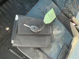 a car seat with a seat belt and a cell phone in it