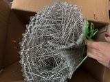 a person that is holding a bunch of pins in a box