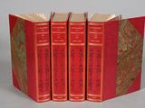 three red books are stacked on top of each other on a table