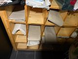 a wooden shelf with towels on it in a room