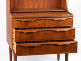 a wooden chest of drawers with three drawers on each side