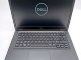 the dell laptop is open and ready to be used on the desk