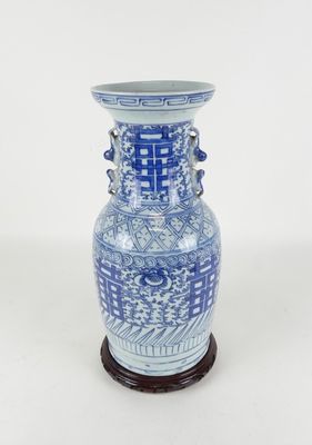 a blue and white vase sitting on a wooden stand