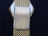 a close up of a watch on a black surface
