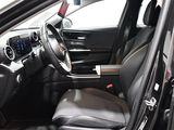 the interior of a car with a black leather seat and steering wheel