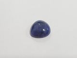 a blue sapphire stone on a white surface