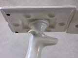 a white object with holes on it that is attached to a pole