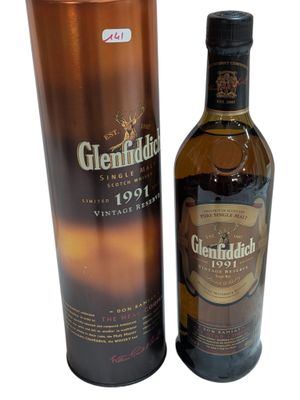a bottle of glenfiddie whisky next to a cardboard box