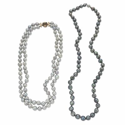 a close up of a necklace and a strand of pearls
