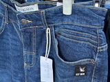 a pair of jeans hanging on a rack in a clothing store