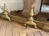 une paire de bougies en laiton posées par terre près d'une porte