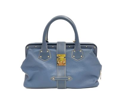 un sac à main en cuir bleu avec des finitions dorées sur la poignée