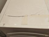 a white refrigerator sitting in the corner of a room