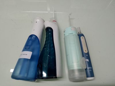 three different types of electric toothbrushes on the counter