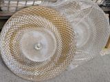 a pile of white plates and a basket on the floor