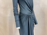 the mannequin is wearing a gray dress with a knot around the waist