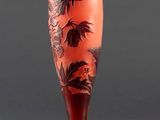 an image of a red vase with flowers on it