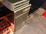 bottles of wine are in a crate under a counter