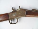an old gun with a wooden handle on a white surface