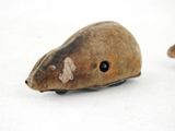 a small mouse that is sitting on a white surface
