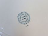 a close up of a plate with a blue and white design on it