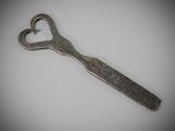 a metal spoon with a heart shaped handle on it