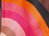 a close up of a scarf with a rainbow design on it