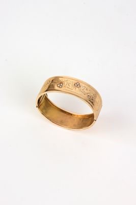 a close up of a gold ring on a white surface