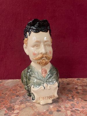 a ceramic figurine of a man with a beard and mustache